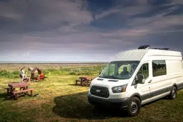 white van on green grass field during daytime