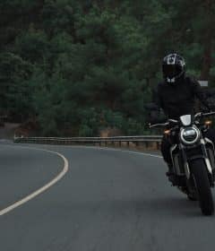 man riding motorcycle on concrete street